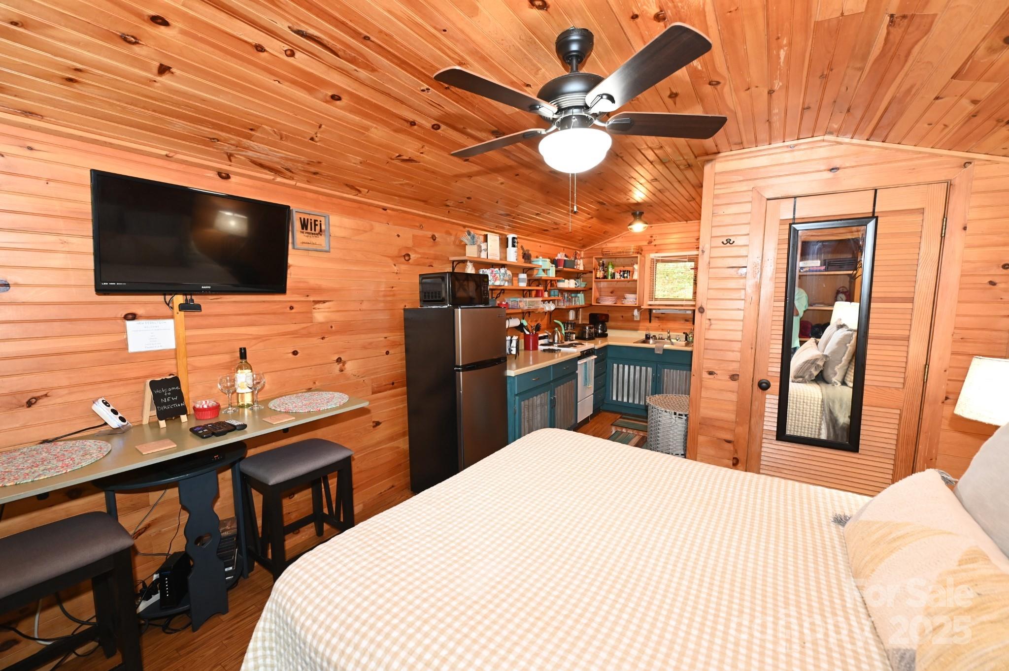 3430 Rose Creek Road Morganton, NC 28655 - Photo 28 of 48 a bedroom with a bed and a flat screen tv