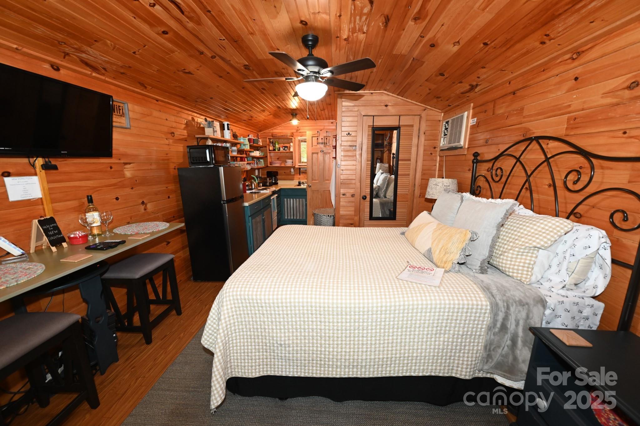 3430 Rose Creek Road Morganton, NC 28655 - Photo 30 of 48 a bed room with a bed and a flat screen tv