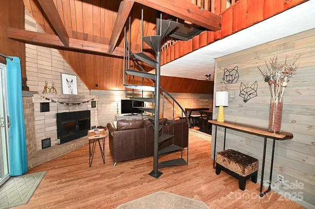 a view of entryway livingroom and hall with wooden floor