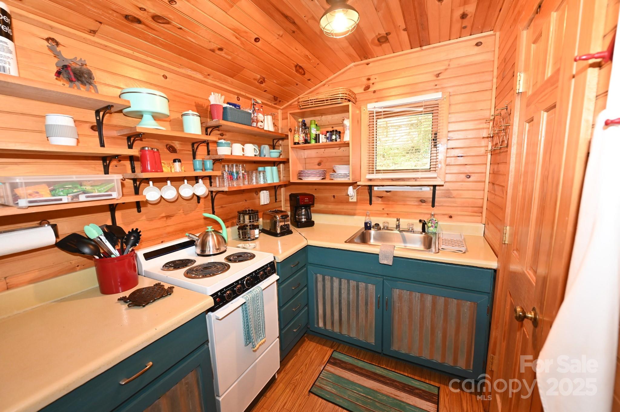 3430 Rose Creek Road Morganton, NC 28655 - Photo 33 of 48 a kitchen that has a sink and a stove