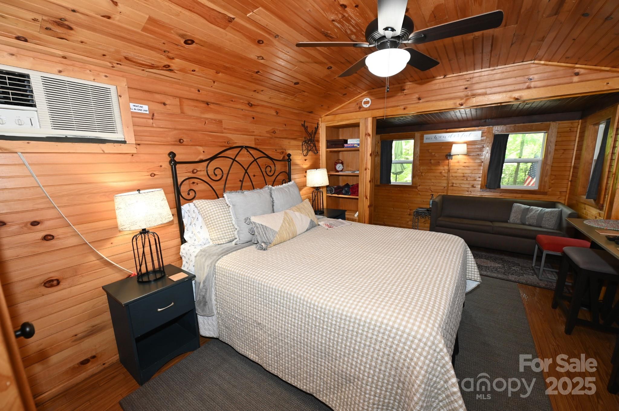 3430 Rose Creek Road Morganton, NC 28655 - Photo 36 of 48 a bedroom with a bed and a chandelier