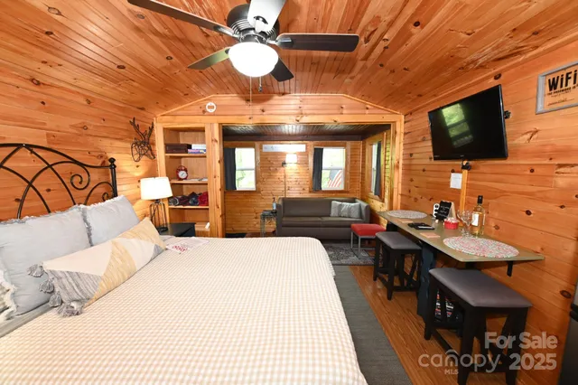 a backyard of a house with plants and large trees