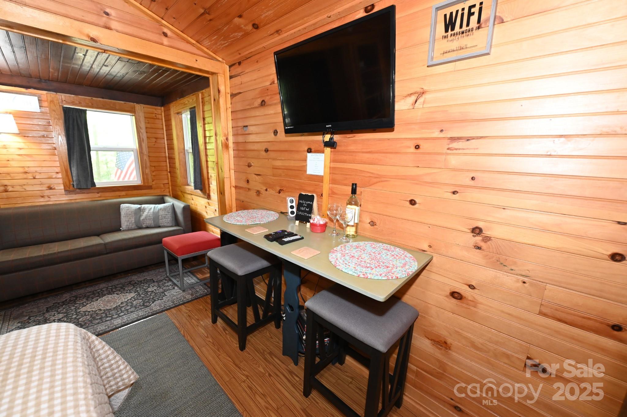 3430 Rose Creek Road Morganton, NC 28655 - Photo 38 of 48 a view of a workspace with a table and a couch