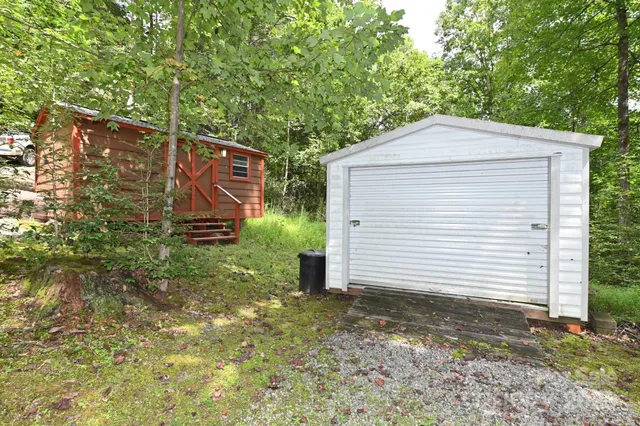 a view of a field with trees in the background