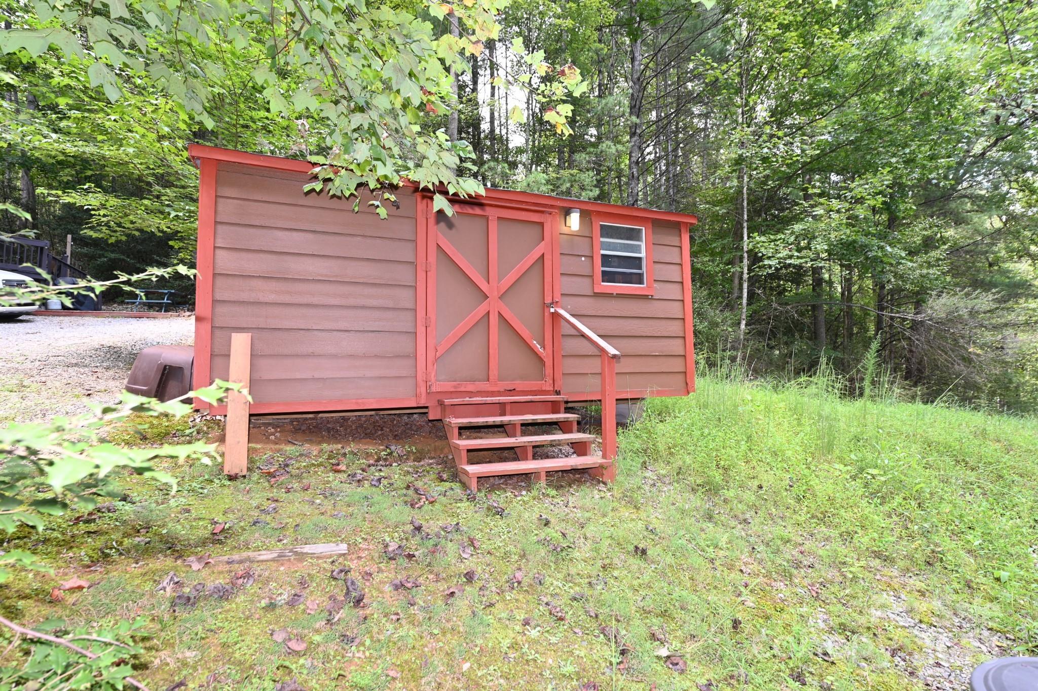 3430 Rose Creek Road Morganton, NC 28655 - Photo 41 of 48 a backyard of a house with plants and large trees