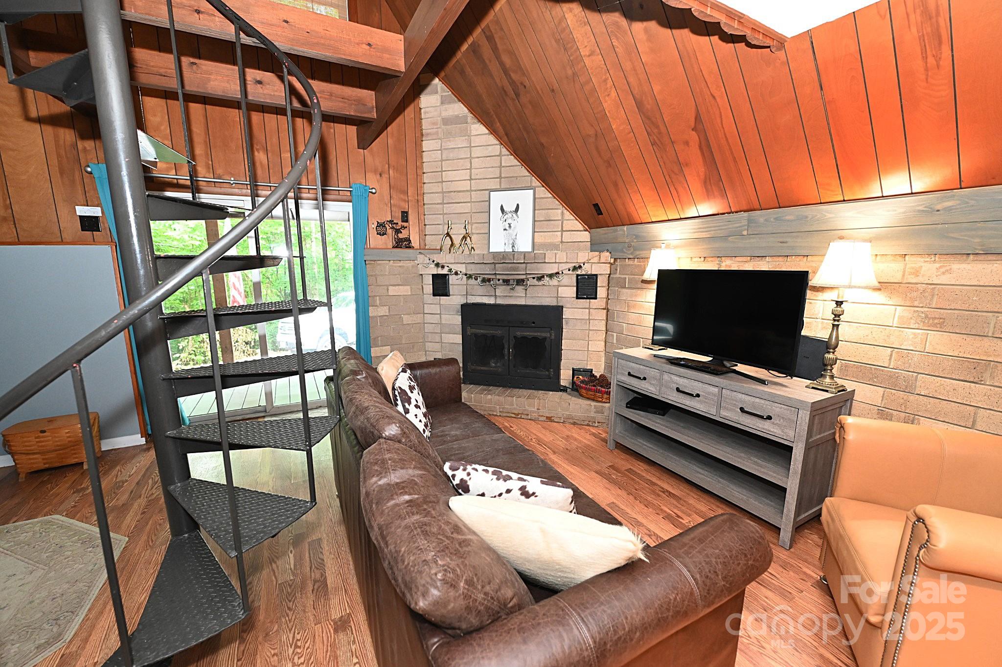 3430 Rose Creek Road Morganton, NC 28655 - Photo 5 of 48 a living room with furniture a flat screen tv and a fireplace