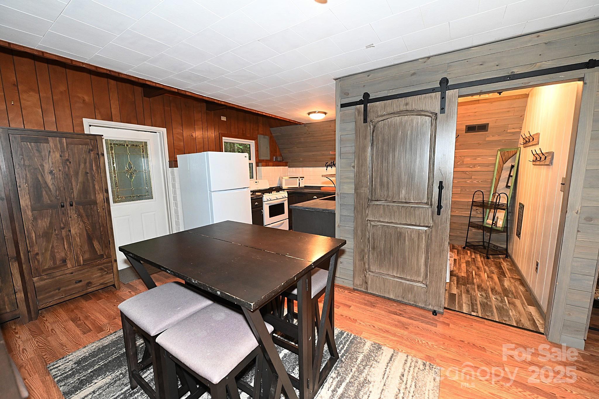 3430 Rose Creek Road Morganton, NC 28655 - Photo 6 of 48 a kitchen with stainless steel appliances granite countertop a refrigerator a stove a sink a dining table and chairs