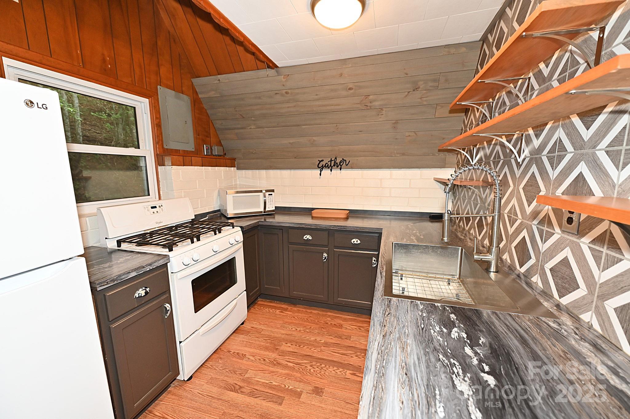 3430 Rose Creek Road Morganton, NC 28655 - Photo 7 of 48 a kitchen with a stove and a microwave