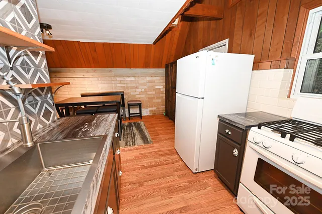 a stove top oven sitting inside of a kitchen