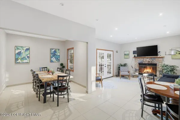 a dining room with furniture and wooden floor