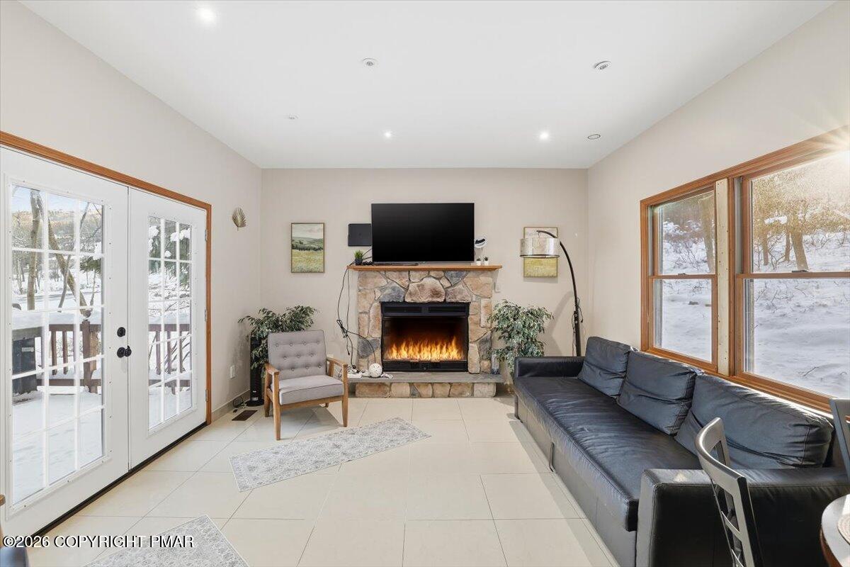 782 Lower Deer Valley Road Tannersville, PA 18372 - Photo 19 of 56 a living room with furniture a flat screen tv and a fireplace