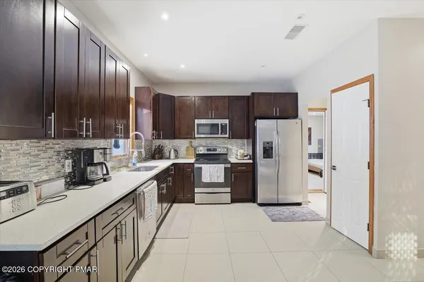 a view of kitchen with furniture and flat screen tv