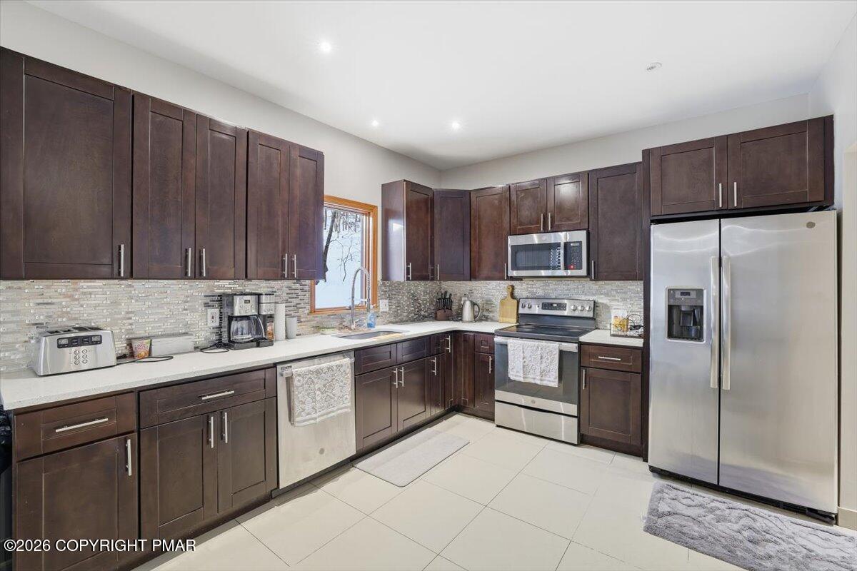 782 Lower Deer Valley Road Tannersville, PA 18372 - Photo 24 of 56 a kitchen with a sink stove and refrigerator