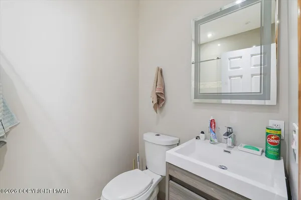 a living room with furniture a piano and a flat screen tv
