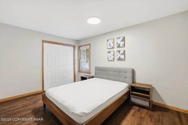 a bedroom with a bed and a wall painting