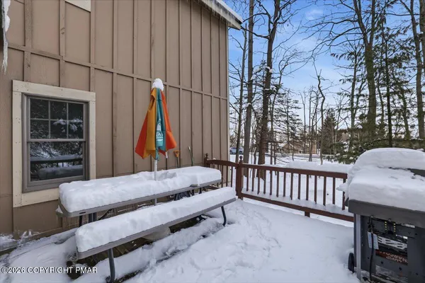 a view of a chairs and table in the back yard of the house