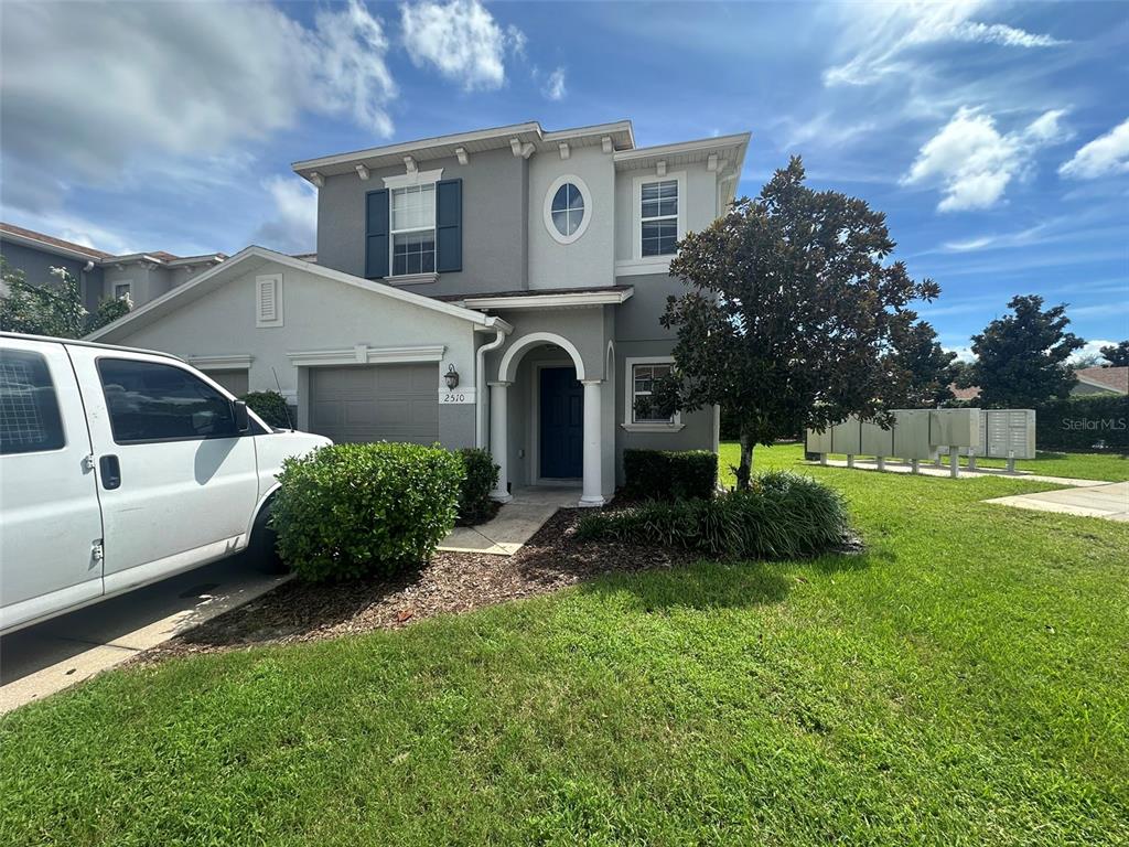 a front view of a house with a yard