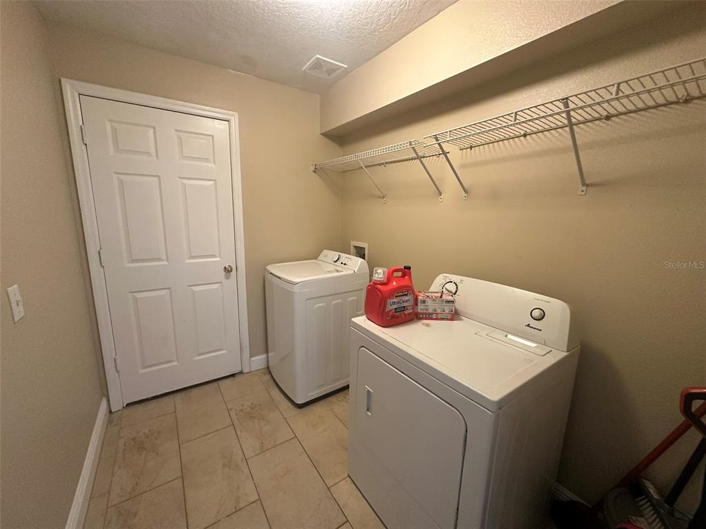 2510 Hassonite Street Kissimmee, FL 34744 - Photo 13 of 22 a utility room with dryer and washer