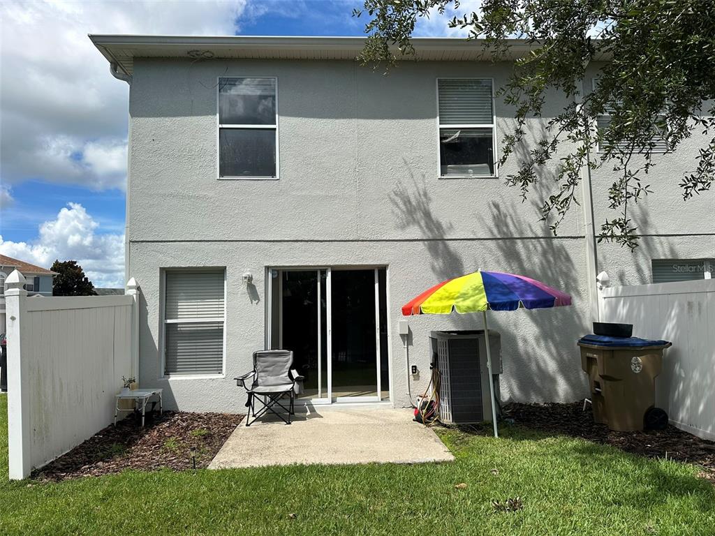 2510 Hassonite Street Kissimmee, FL 34744 - Photo 15 of 22 a backyard of a house with table and chairs