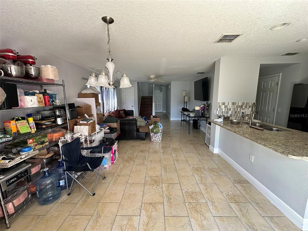 2510 Hassonite Street Kissimmee, FL 34744 - Photo 4 of 22 a living room with lots of furniture and a chandelier