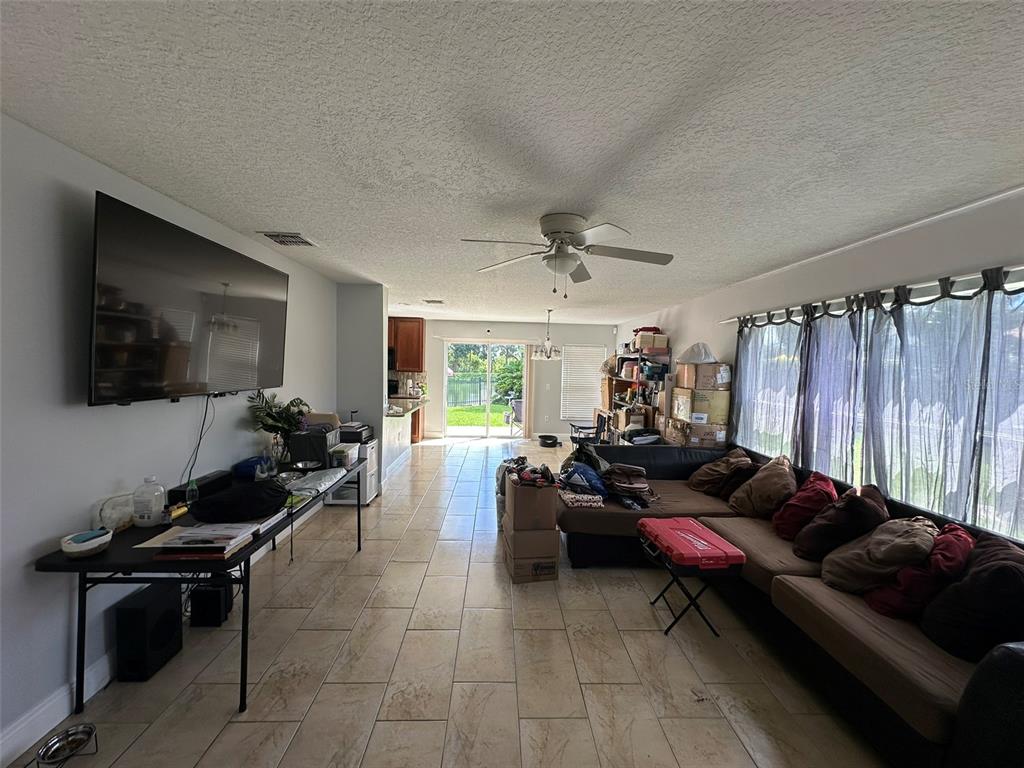 2510 Hassonite Street Kissimmee, FL 34744 - Photo 5 of 22 a living room with furniture and a flat screen tv