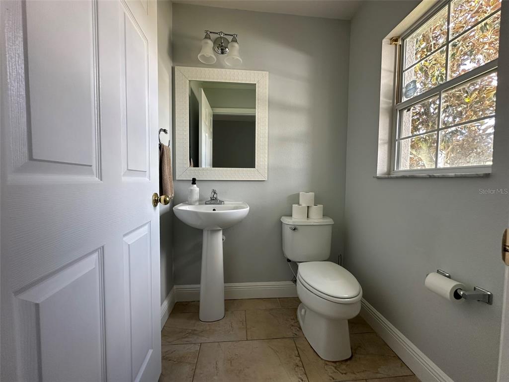 2510 Hassonite Street Kissimmee, FL 34744 - Photo 7 of 22 a bathroom with a toilet sink and mirror
