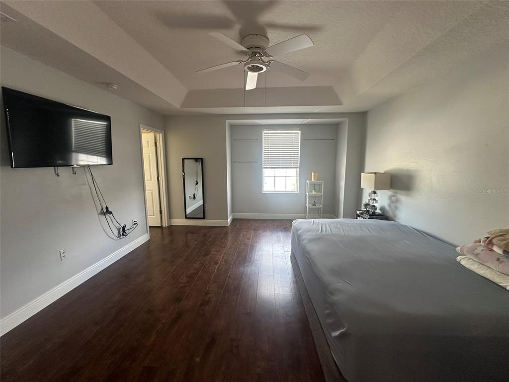 2510 Hassonite Street Kissimmee, FL 34744 - Photo 10 of 22 a bedroom with a bed and a flat screen tv