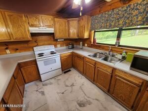 2880 Fairview Road Madisonville, TN 37354 - Photo 15 of 37 a kitchen with stainless steel appliances granite countertop sink stove and cabinets