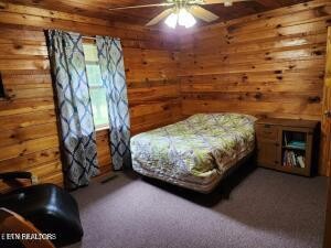 2880 Fairview Road Madisonville, TN 37354 - Photo 28 of 37 a bed sitting in a room next to a lamp