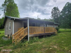 2880 Fairview Road Madisonville, TN 37354 - Photo 37 of 37 a view of a deck with a small yard and large trees