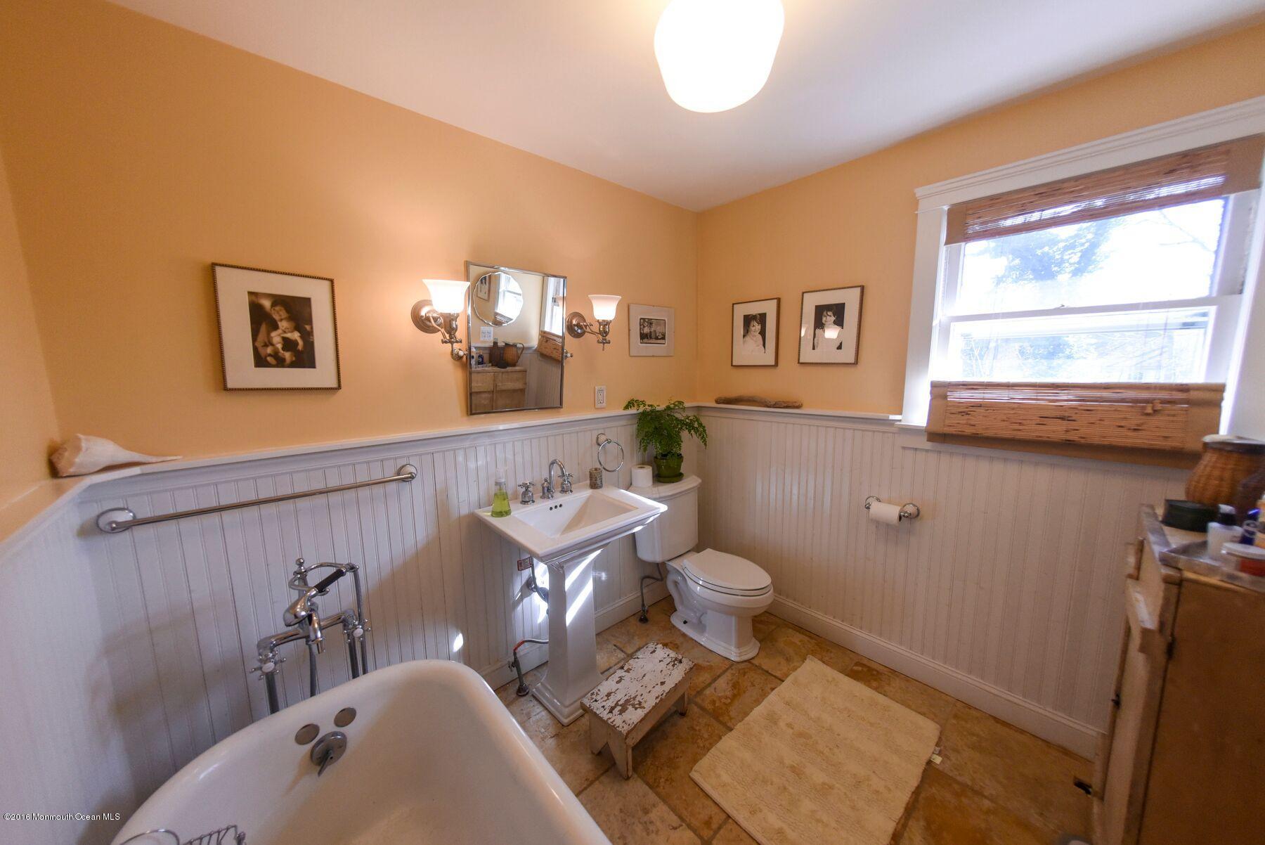 89 Pinckney Road Red Bank, NJ 07701 - Photo 14 of 26 a bathroom with a sink a toilet and a mirror