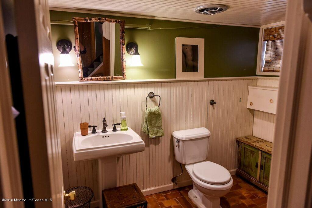 89 Pinckney Road Red Bank, NJ 07701 - Photo 20 of 26 a bathroom with a toilet a sink and mirror