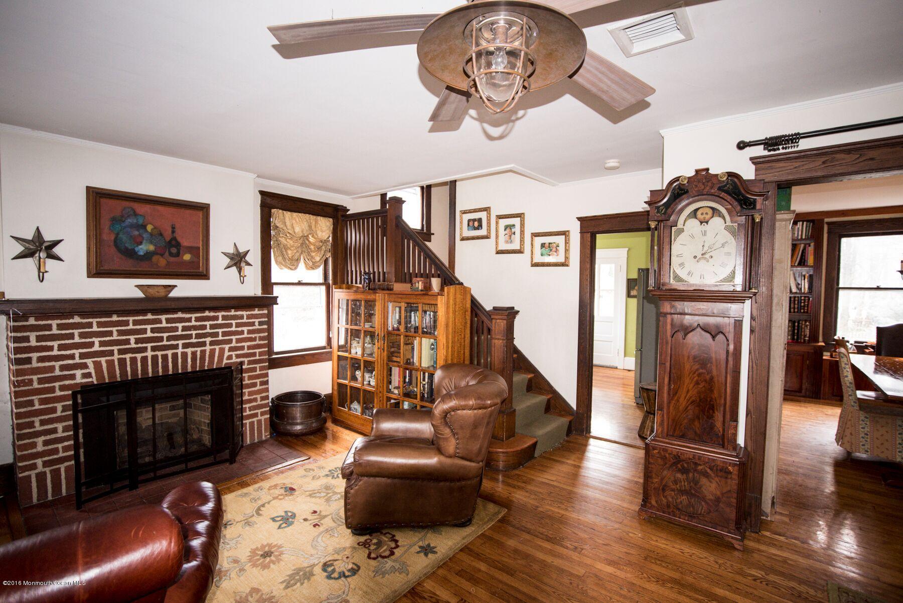 89 Pinckney Road Red Bank, NJ 07701 - Photo 4 of 26 a living room with furniture and a fireplace