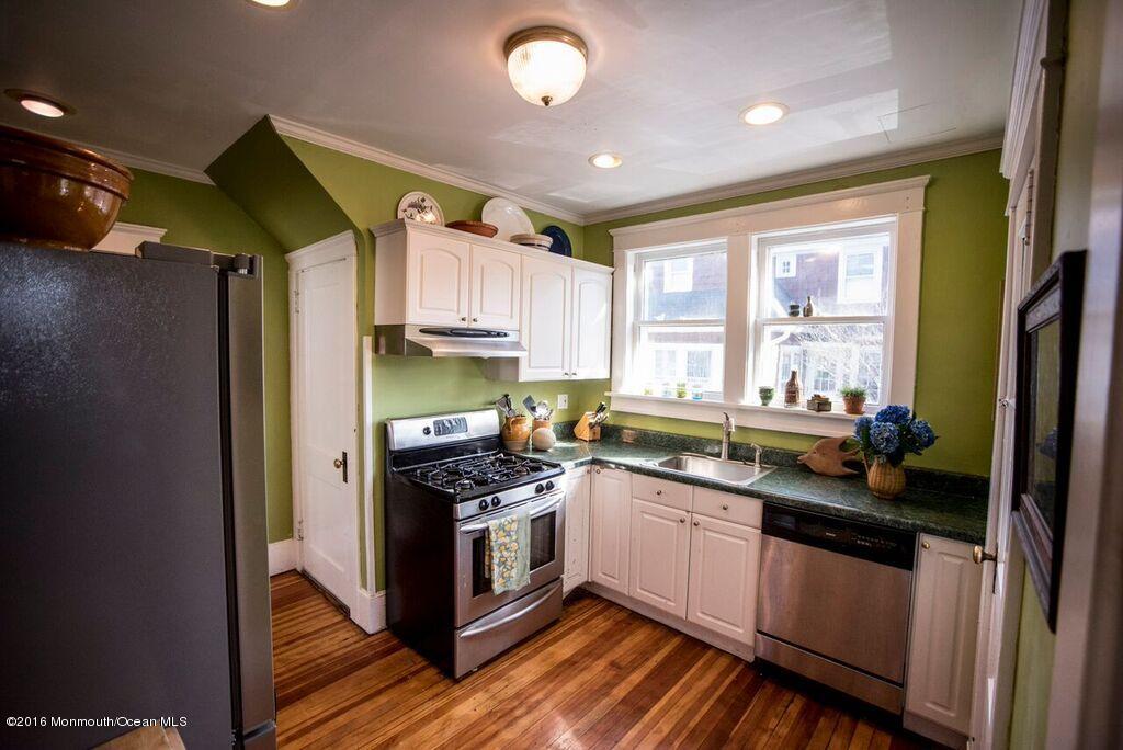 89 Pinckney Road Red Bank, NJ 07701 - Photo 6 of 26 a kitchen with stainless steel appliances a sink cabinets and wooden floor