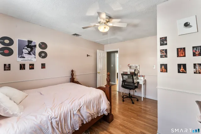 a bedroom with furniture and a wooden floor