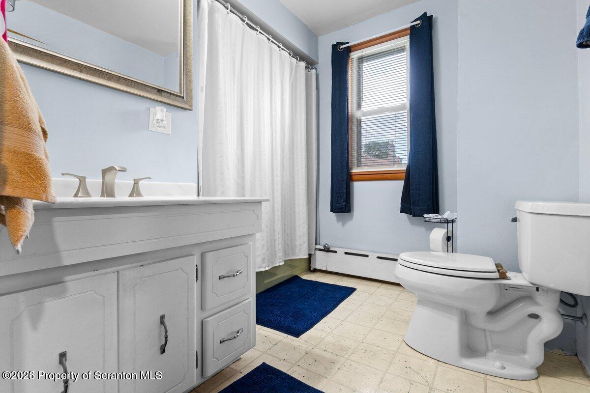 2129 Comegys Avenue Scranton, PA 18509 - Photo 11 of 22 a bathroom with a sink toilet and window