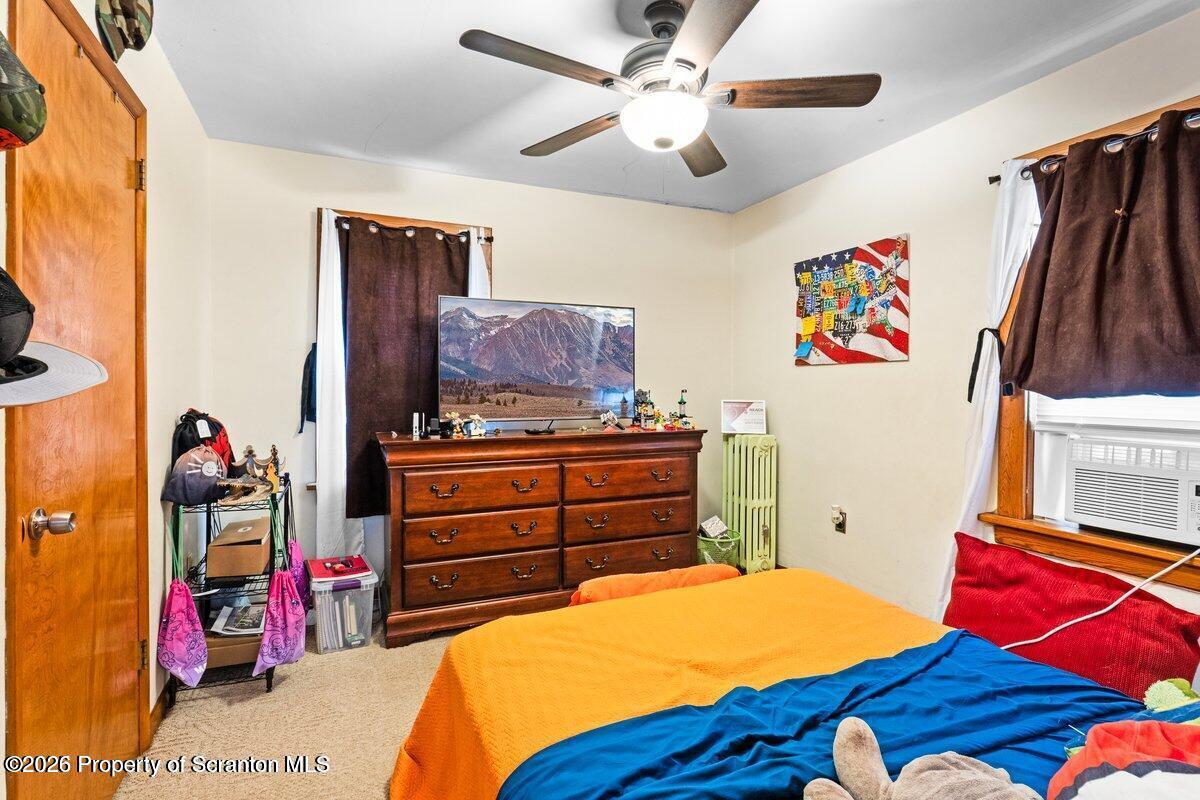 2129 Comegys Avenue Scranton, PA 18509 - Photo 12 of 22 a bedroom with a bed and a chandelier