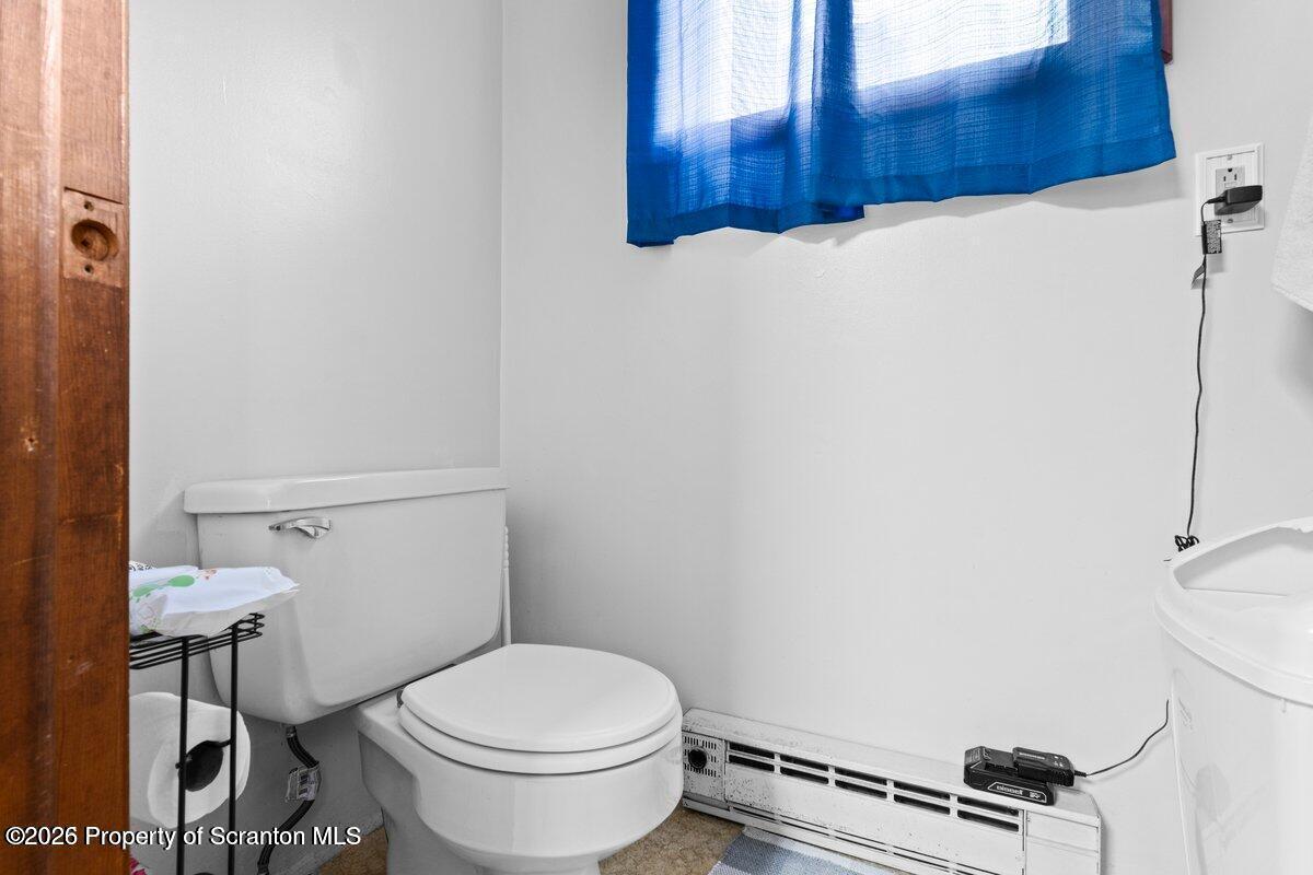 2129 Comegys Avenue Scranton, PA 18509 - Photo 15 of 22 a white toilet sitting next to a bathroom sink