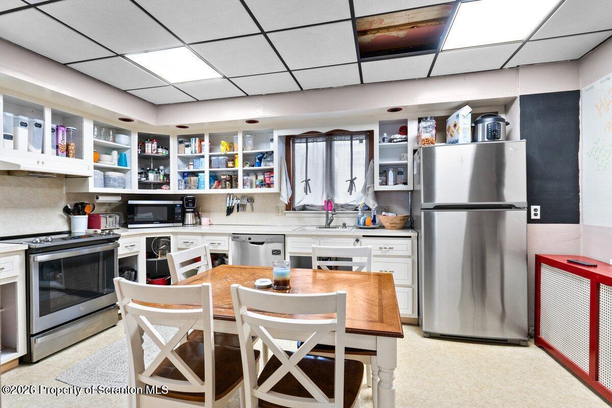 2129 Comegys Avenue Scranton, PA 18509 - Photo 7 of 22 a kitchen with stainless steel appliances granite countertop a refrigerator and a stove top oven