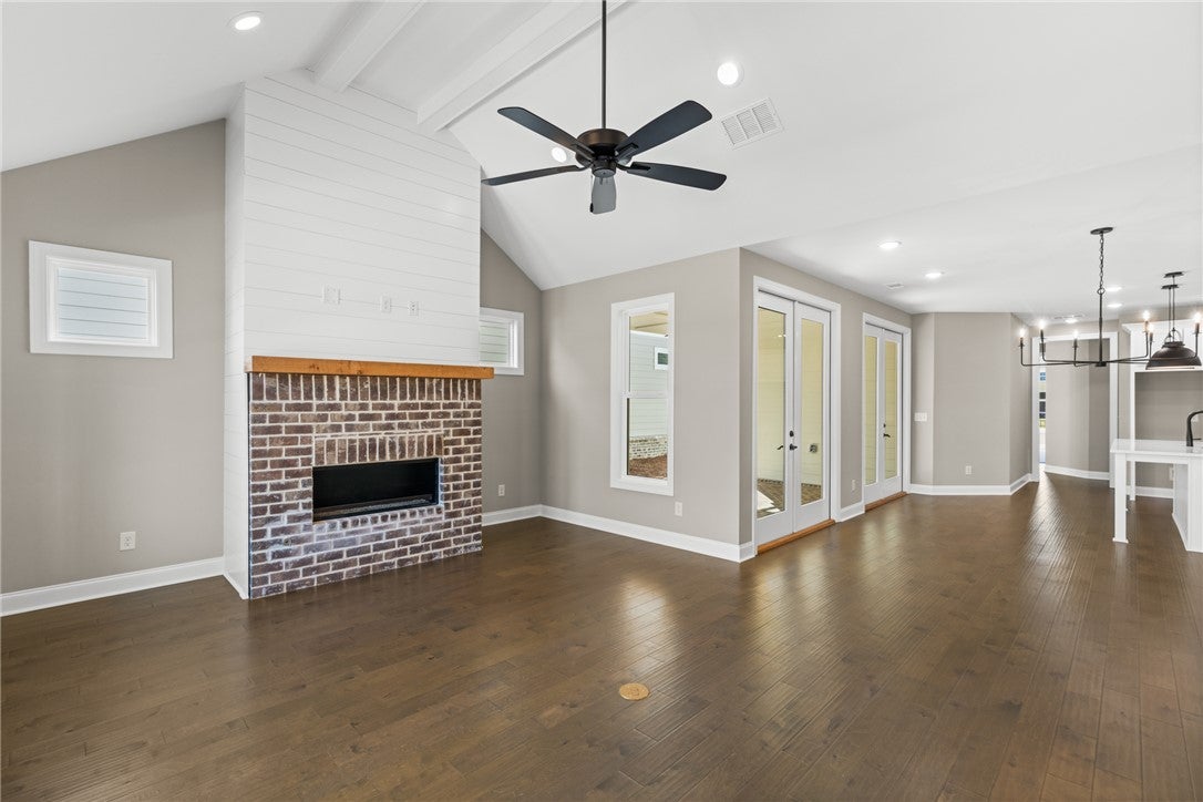 320 Coscoroba Road Auburn, AL 36832 - Photo 4 of 27 This living space features hardwood floors and a fireplace, creating a warm and inviting atmosphere.
