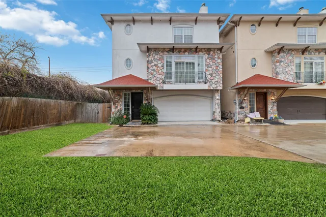 a front view of a house with yard and patio