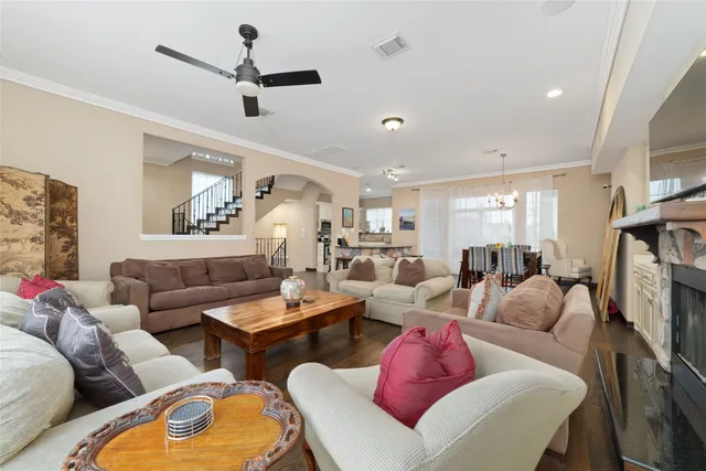 a living room with furniture a ceiling fan and a fireplace
