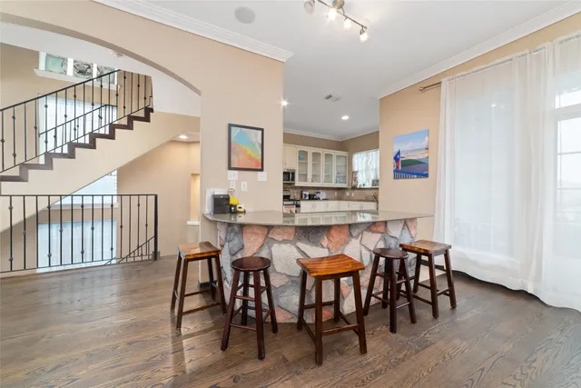 a dining room with furniture and wooden floor