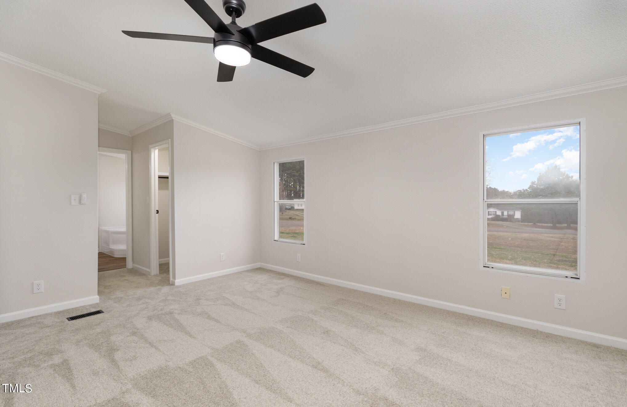 1183 Diamond Hills Road Stem, NC 27581 - Photo 15 of 28 an empty room with windows and fan