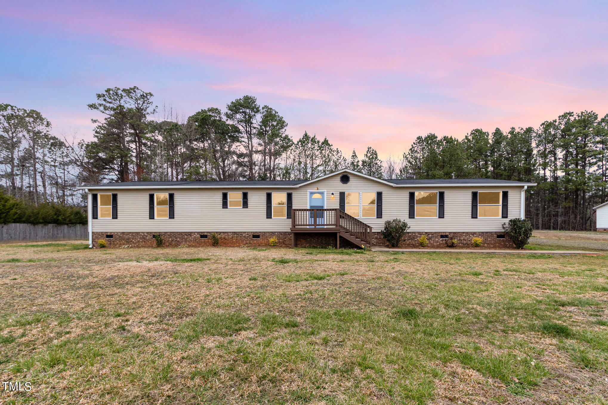 1183 Diamond Hills Road Stem, NC 27581 - Photo 23 of 28 a front view of a house with a garden