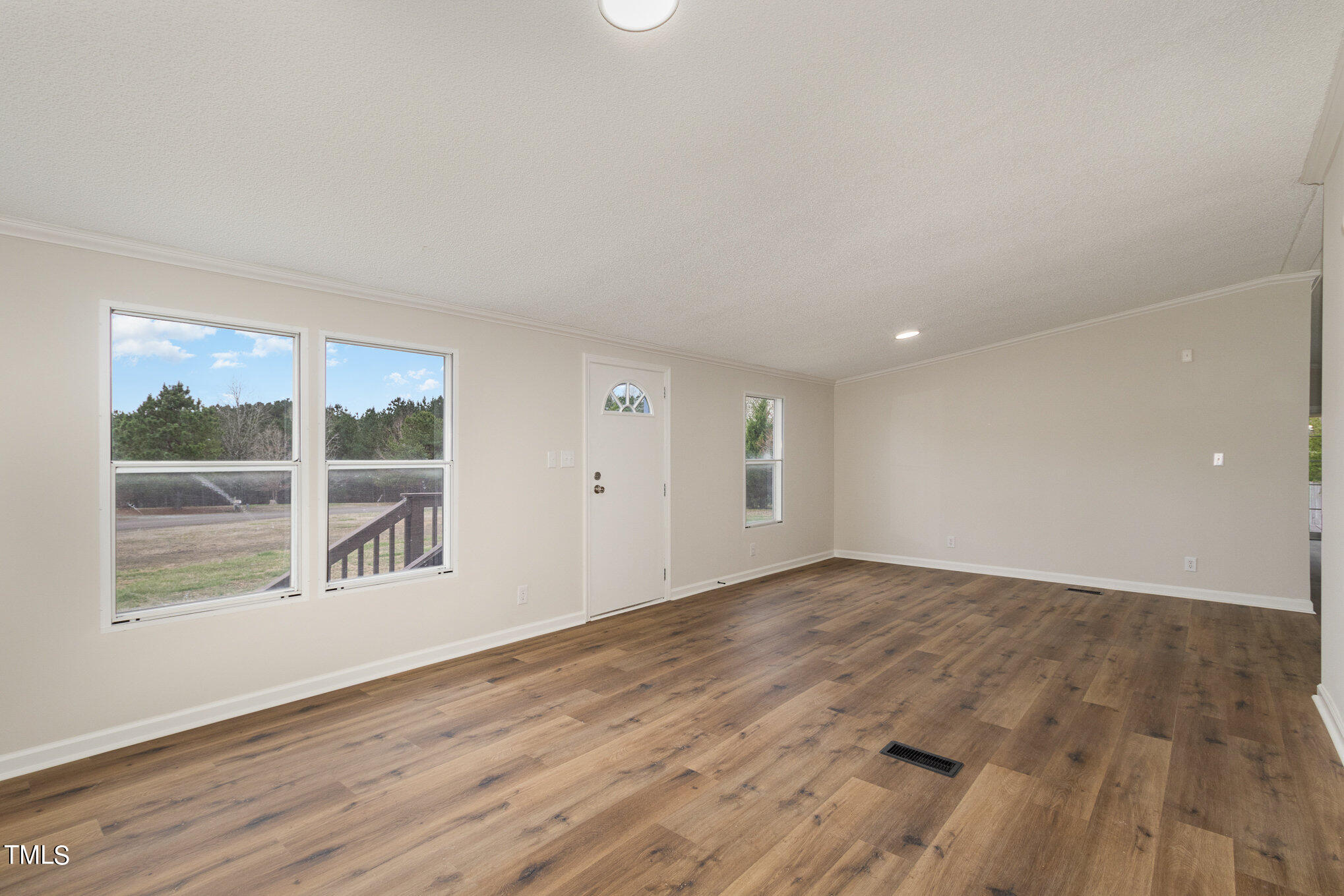 1183 Diamond Hills Road Stem, NC 27581 - Photo 4 of 28 a view of an empty room with wooden floor and a window