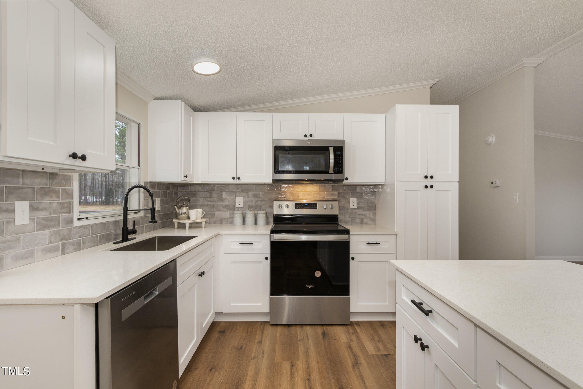 1183 Diamond Hills Road Stem, NC 27581 - Photo 7 of 28 a kitchen with a sink appliances and cabinets