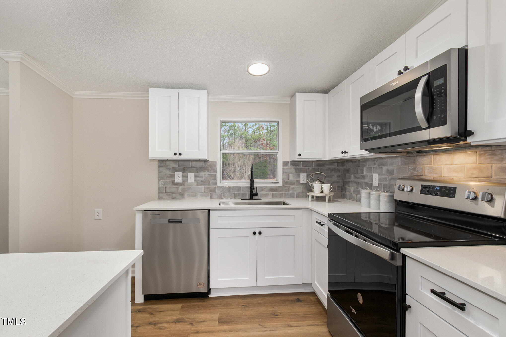 1183 Diamond Hills Road Stem, NC 27581 - Photo 8 of 28 a kitchen with stainless steel appliances a sink stove and microwave