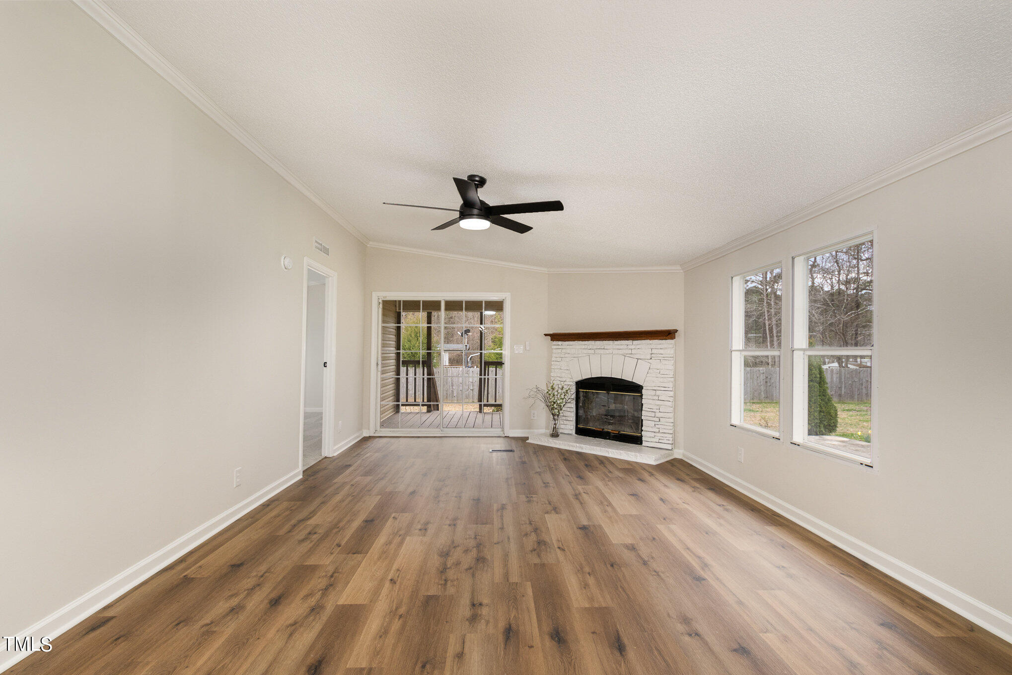 1183 Diamond Hills Road Stem, NC 27581 - Photo 10 of 28 a view of wooden floor a fireplace and windows in a room