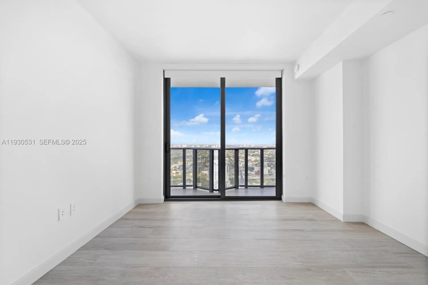 55 Southwest 9th Street, Unit 3806 Miami, FL 33130 - Photo 14 of 24 a view of an empty room with a window